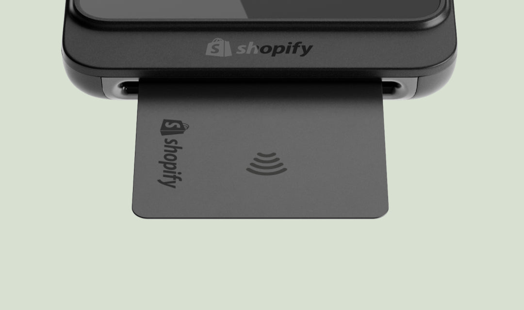 Card reader and Shopify-branded payment card showing 'shopify' and a contactless payment symbol