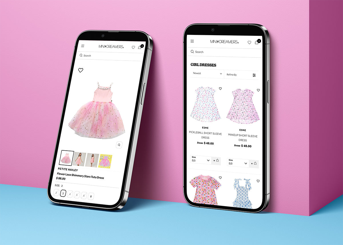 Two phones on pink background showing Mini Dreamers mobile site: 'PETITE HAILEY' product and 'GIRL DRESSES' category.