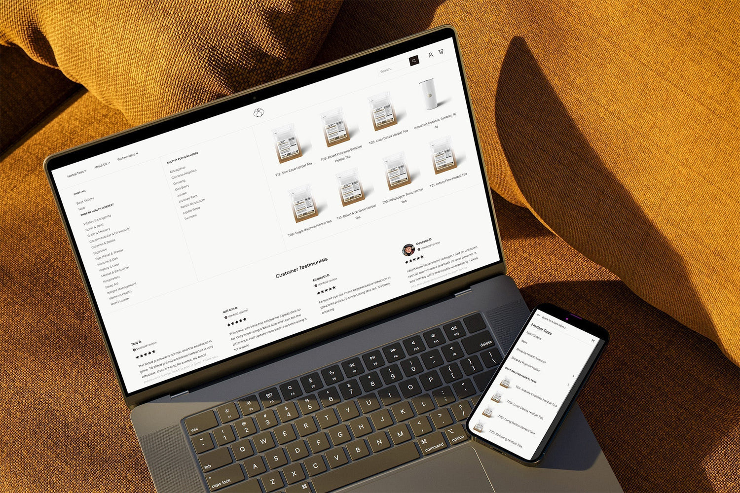 Laptop and smartphone showing Arcane Herb product listings, menu with 'Herbal Teas' and site section 'Customer Testimonials'
